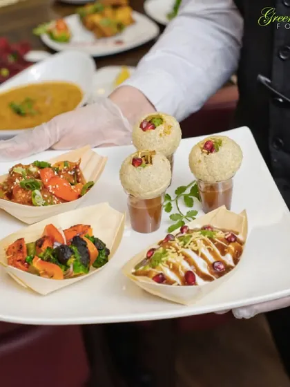 A platter of happiness, showcasing the variety we love to serve. Here you can see our innovative pani puri shots, savory dahi puri, and flavorful stir-fried starters. We design our menus to offer a delightful journey of tastes and textures for your guests.