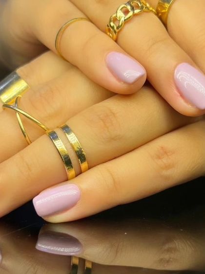 A simple and clean manicure with a solid, soft lilac-pink polish on square-shaped nails.