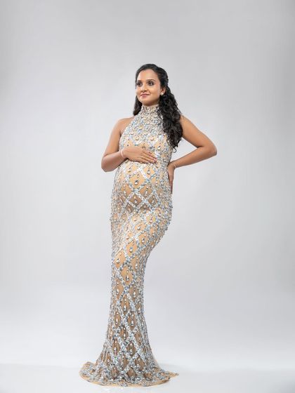For the ultimate glamorous look, this fully embellished silver and nude gown is a showstopper. It sparkles and shines, creating a truly luxurious portrait.