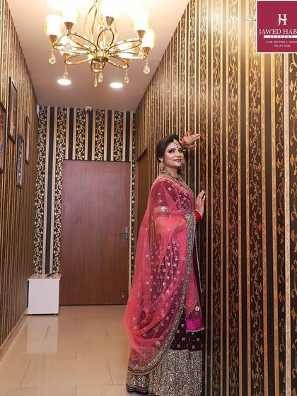 A stylish shot of the bride in the academy corridor, showing off the beautiful lehenga and makeup.