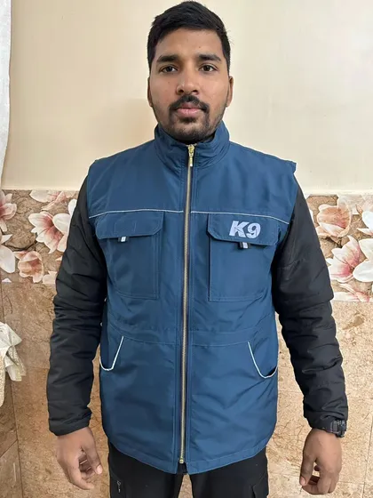 This is a straight-on view of the blue trainer vest. The K9 logo shows your professional commitment, and the zippered front keeps everything secure, whether you're running, bending, or working a dog.