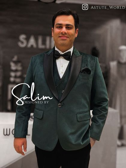 A client in a deep green velvet three-piece tuxedo. The rich color and fabric offer a luxurious alternative to the standard black tuxedo.