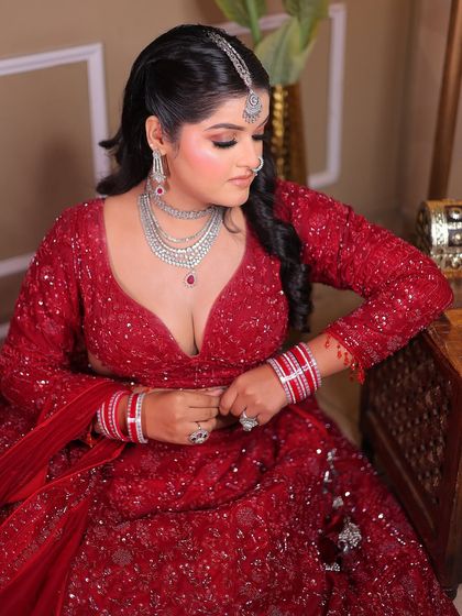 A candid moment of the bride adjusting her bangles, adding a touch of natural movement.