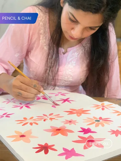 A student works on a pattern of pink watercolor flowers. This exercise in repetition and color variation is a great way to build brush control and confidence.