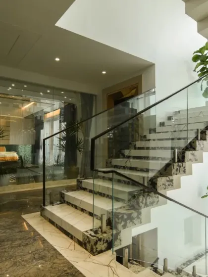 Additional views showcasing the interplay of glass walls, marble floors, and wooden slat details. These images highlight how we use materials to define spaces and create visual continuity.