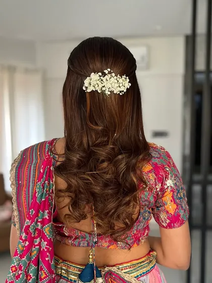 Another view of this beautiful engagement hairstyle. The baby's breath flowers add a delicate and romantic touch to the soft curls.