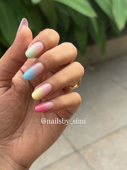 A single hand shot showcasing the beautiful, soft gradient of these pastel ombre nails. It's a subtle yet colorful statement.