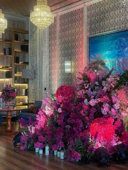 Another view of the stunning pink floral installation, showcasing its scale and the variety of blooms used. The arrangement adds a burst of color and life to the elegant, wood-paneled room, perfectly blending modern design with classic architecture.