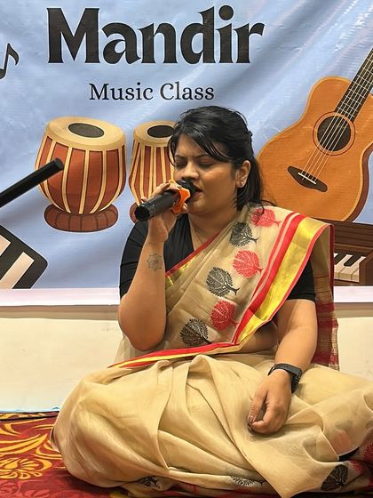 Here I am, singing at one of our events. I believe it is important for a guru to also be a performer, to lead by example and share the joy of music with my students.