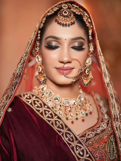 A close-up of a celebrity-inspired bridal look. The focus is on the dramatic winged eyeliner and the soft, blended eyeshadow.