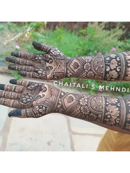 This is a side view of a traditional bridal mehendi design. You can see the detailed elephant motifs at the elbow and the intricate floral and geometric patterns covering the arm.