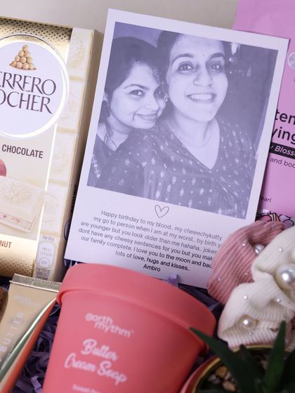 A personalized sister birthday hamper with a custom polaroid-style photo and a heartfelt message.