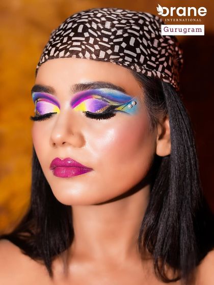 This shot captures the full impact of the colorful eye makeup against a warm background. I teach students about color theory to create harmonious and striking combinations.