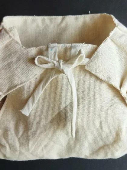 A close-up of a handwoven, unbleached cotton nappy. We support and share information about products that are gentle on a baby's skin and free from potentially harmful chemicals found in many mass produced textiles.