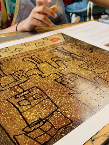 A close-up of a finished drawing, showcasing simple yet expressive cubist-style figures.