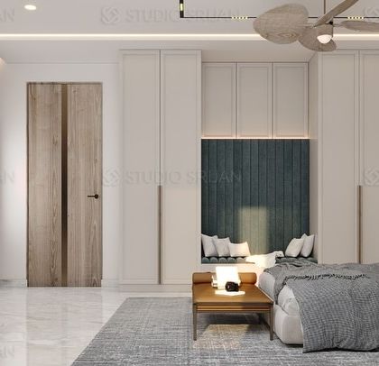 This angle highlights the bedroom's TV wall and the entrance to the walk-in closet. The design incorporates a bay window seating area with a fluted backrest, providing a comfortable reading nook.