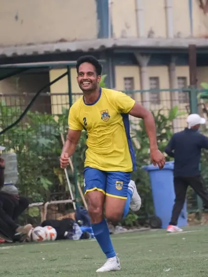 Our academy coach celebrating after scoring a goal, leading by example on the pitch.