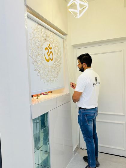 A closer look at the mandir with the 'Om' blind, a simple yet elegant solution for a prayer space.