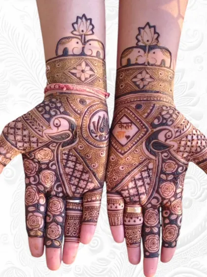 A stunning full-hand design perfect for Teej, featuring symmetrical patterns with bold peacocks, delicate roses, and royal elephants at the wrist. This is a great example of traditional Rajasthani mehendi.