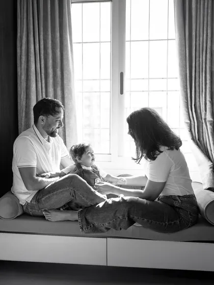 A quiet moment by the window can say so much. Using beautiful natural light, I create timeless, soulful black and white portraits that capture the peaceful comfort of being at home with the ones you love.