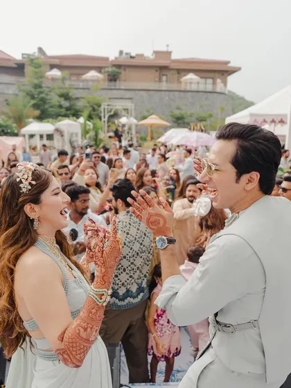 The couple sharing a dance and a laugh in front of their guests, the energy is infectious.