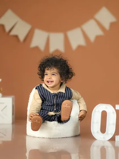 Look who's ONE! I love celebrating first birthdays. We set up everything from the props to the backdrop to capture the pure joy and giggles of this huge milestone. This little one's smile says it all.