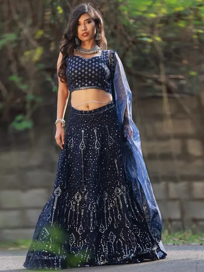 Another take on the Heeramandi theme, this time with a stunning navy blue lehenga. This full-length shot shows the entire outfit and its intricate silver work, captured during an outdoor session in Bangalore.