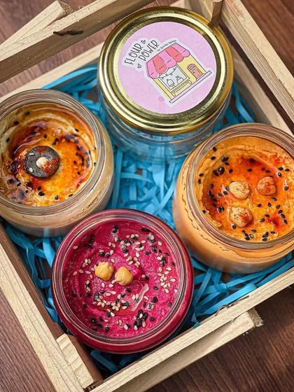 My hampers can be customized with a variety of my dips. This box features three of my most popular hummus flavours: classic, roasted pepper, and beetroot, ready for gifting.
