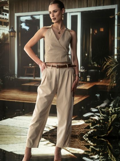 A modern, stylish cabin exterior projected as the background. This technique allows me to create a specific lifestyle setting that perfectly matches the fashion concept.