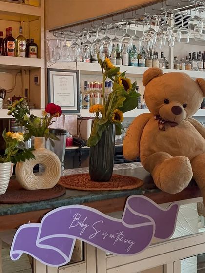 A giant teddy bear sits at the bar, welcoming guests to the baby shower. Fun, cute details like this help bring the theme to life and create a joyful, relaxed vibe.