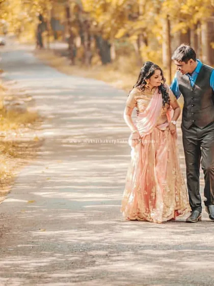 A pre-wedding shoot is like taking a walk into your future together. This cinematic shot on a quiet, tree-lined road captures the start of that beautiful journey.