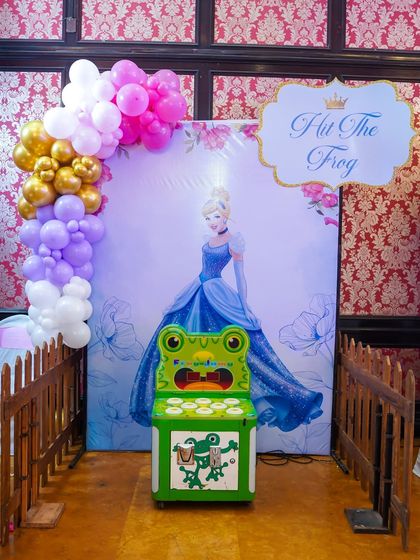 A "Hit the Frog" whac-a-mole style game with a Cinderella backdrop, tying a classic arcade game into the princess theme.