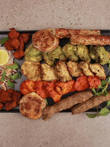 Can't decide what to offer your guests? Our non-veg platter is the answer. It’s a feast of our best offerings, including various chicken tikkas, mutton seekh kebabs, and galouti kebabs, all made with our family's secret masalas.