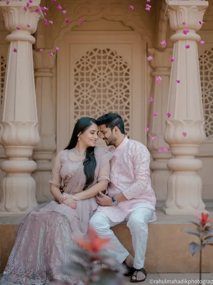 I love creating grand, fairytale-like images. Here, we used the stunning architecture to frame the couple, with flower petals adding a touch of magic. This is for couples who dream of a pre-wedding shoot that feels both royal and romantic.