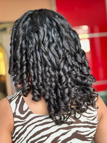 A different view of these perfectly formed curls. Notice how each spiral is distinct and reflects light, which is a sign of well-hydrated and healthy hair. This is what my curl-focused treatments can achieve.
