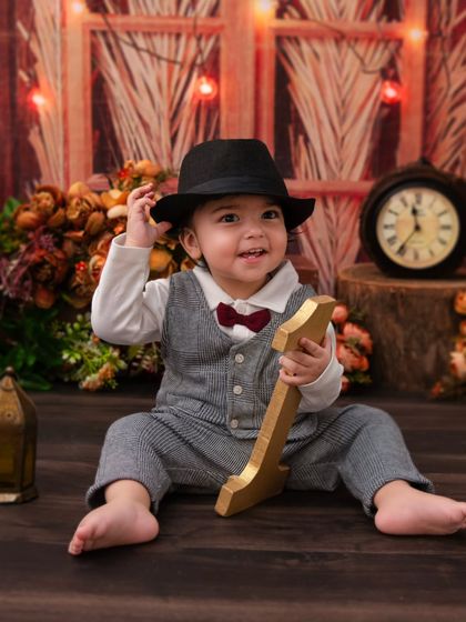 A playful moment from the vintage gentleman shoot. Holding a golden prop, this little boy's smile is absolutely precious.