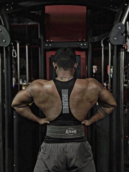 Another angle of the lat spread. The details in the back muscles are the result of consistent, heavy lifting.