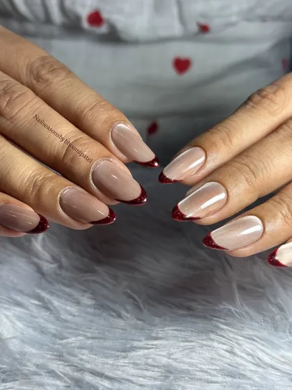 A simple nude base with a classic deep red French tip. Timeless and elegant.