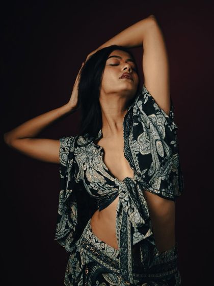 A graceful, eyes-closed pose that conveys a sense of freedom and abandon.