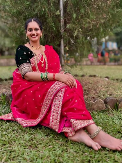 A relaxed and happy pose, showing the comfortable yet regal drape of the Nauvari saree. Perfect for enjoying long ceremonies and functions.