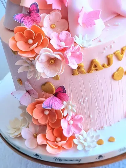 A close-up of the sugar flowers and wafer paper butterflies on the Barbie cake.