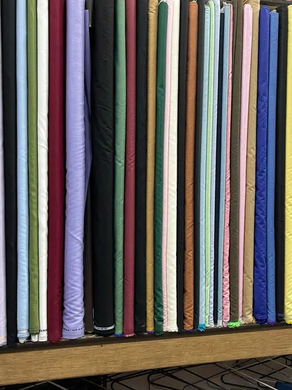 A close up of the solid color fabrics I stock. These are perfect for classic trousers, blazers, and suits, available in a wide spectrum of shades.