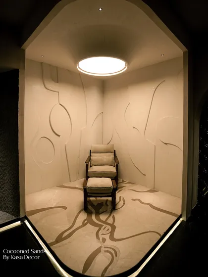 A private, meditative space defined by our 'Cocooned Sands' surface. The abstract, organic lines carved into the walls and floor create a seamless, enveloping feel, proving that a room can be both minimal and deeply expressive.