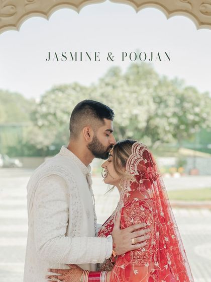 An intimate and classic wedding portrait. The groom gently kisses the bride's forehead, a timeless gesture of love and affection captured beautifully.