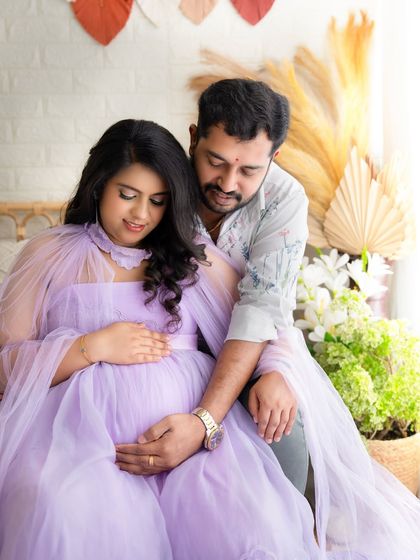 A quiet, intimate moment as the couple gently holds the baby bump. This pose beautifully captures the connection and anticipation of the parents-to-be.