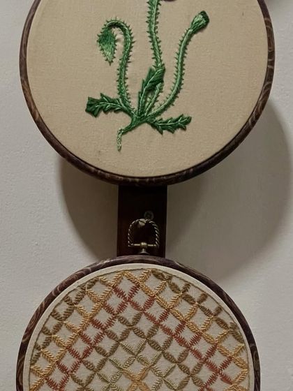 Embroidery can take various forms. Here you see two different styles of hoop art, one with a botanical design and the other with a geometric Kasuti pattern.