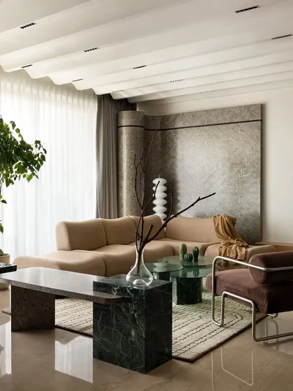 Another angle of the 'ARAH' living room, showcasing the custom marble bench and the way it interacts with the other furniture pieces. The design is a testament to the trust our client placed in our vision.