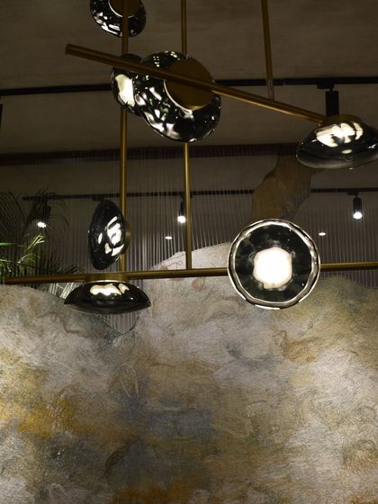 A detailed shot of the Ceto chandelier's glass elements, which capture the texture and movement of water.