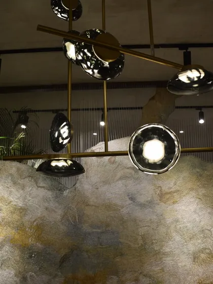A detailed shot of the Ceto chandelier's glass elements, which capture the texture and movement of water.