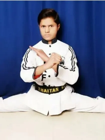 Age is just a number. This is my little master Zainul, a black belt who has achieved a level of discipline and flexibility that many adults only dream of. He shows perfect form in a full split, a testament to his dedication.